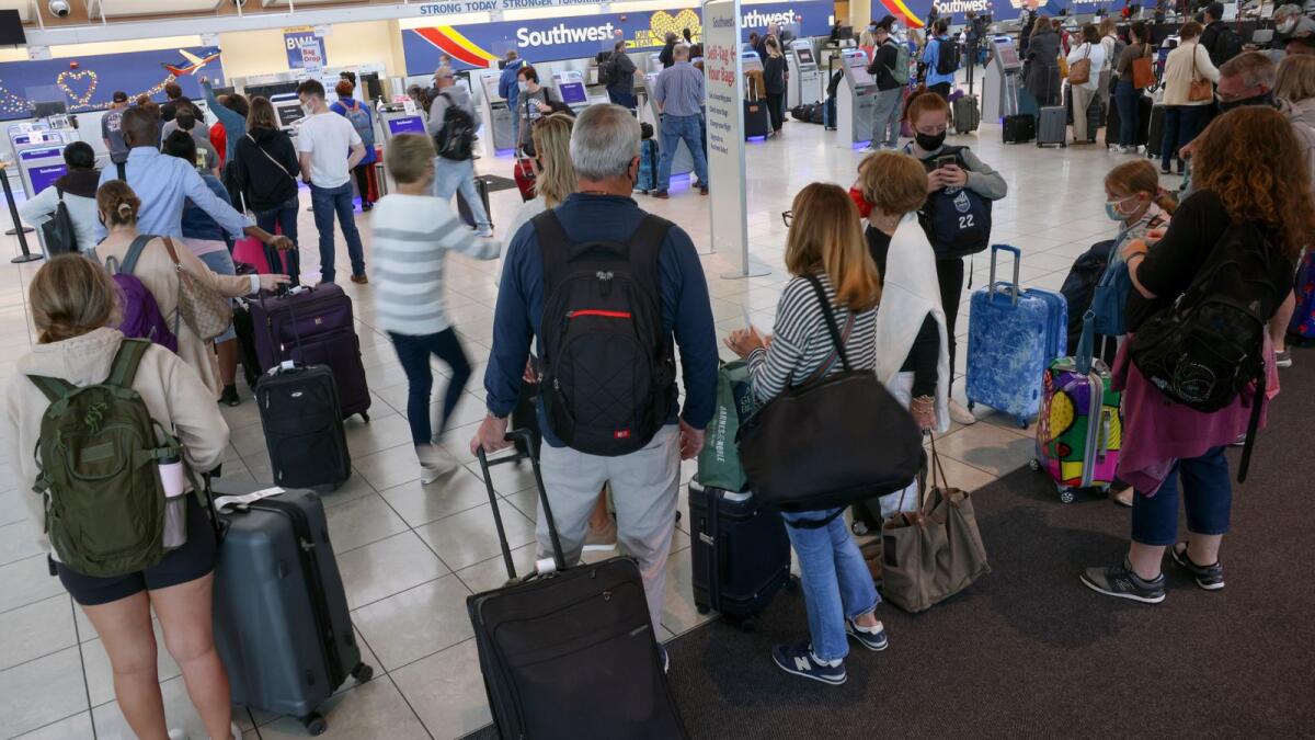 Travellers wait to check in at the Southwest Airlines ticketing counter at Baltimore Washington International Thurgood Marshall Airport on October 11, 2021 in Baltimore, Maryland. (AFP)