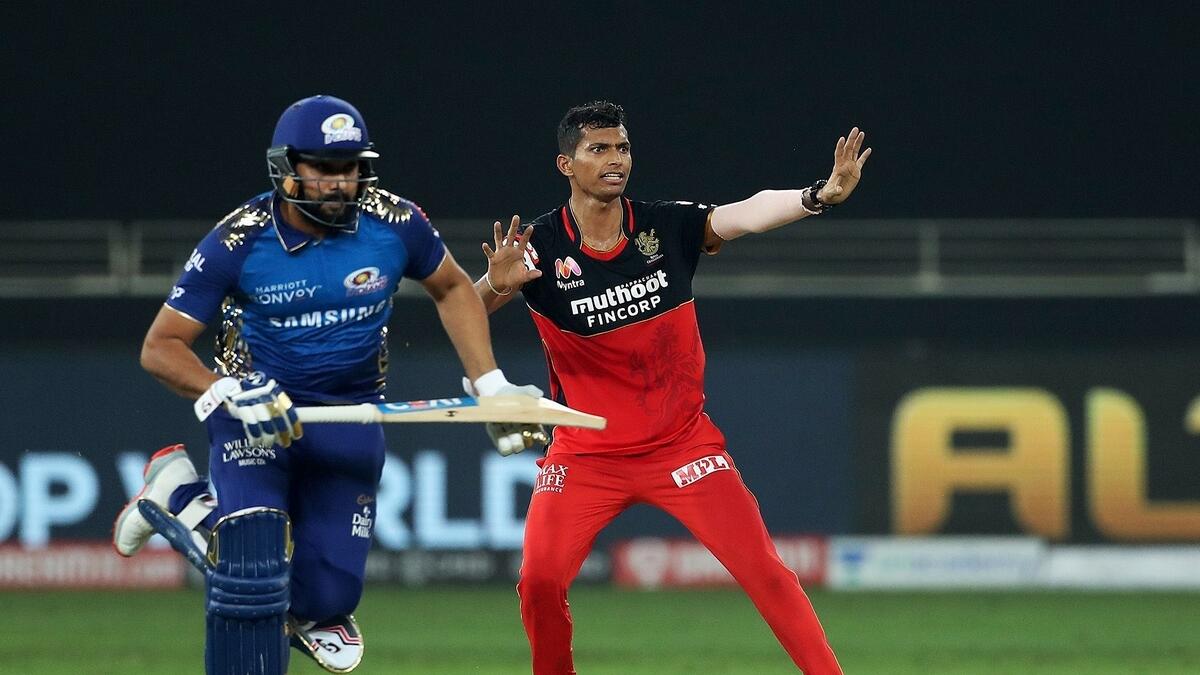 RCB's Navdeep Saini reacts as MI skipper attempts to take a run in the Super Over at the Dubai International Cricket Stadium on Monday. - IPL