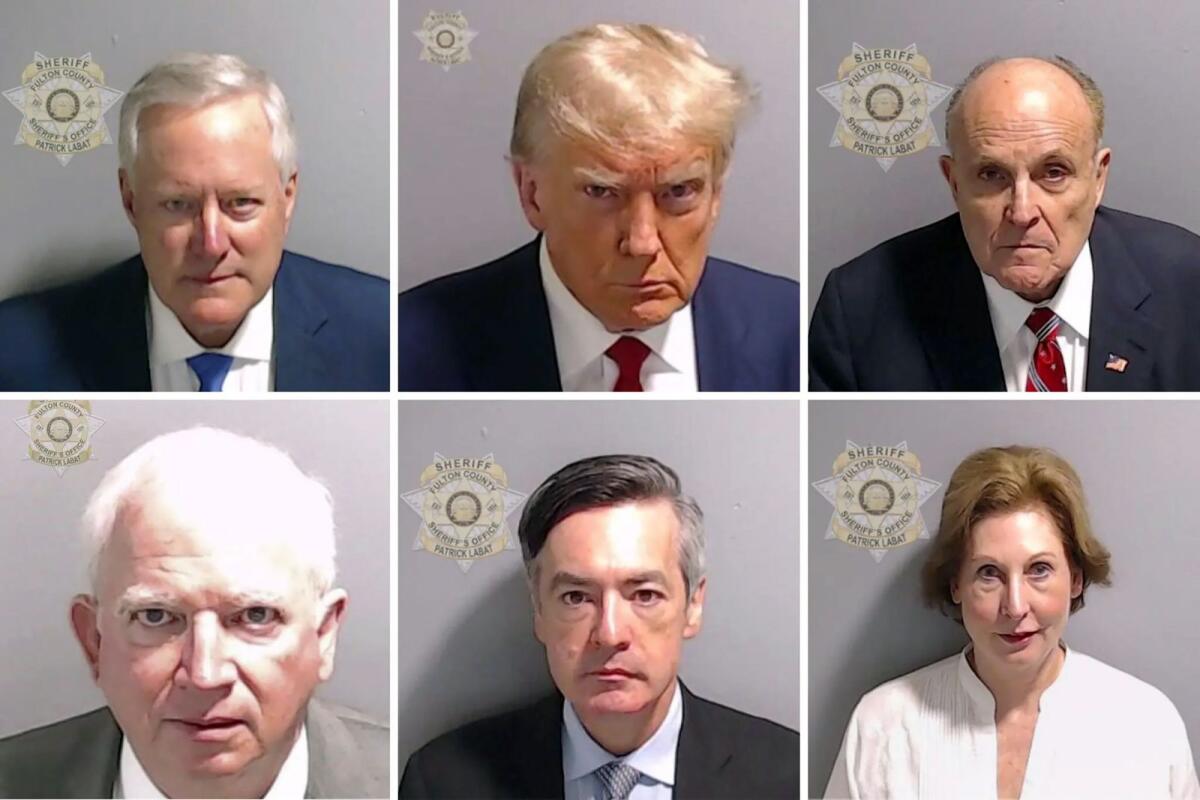 Former president Donald Trump, top row centre, and several of his fellow defendants, in mug shots released by the Fulton County Sheriff’s Office in Atlanta. Top row, from left: Mark Meadows; Trump; Rudy Giuliani. Second row, from left: John Eastman; Kenneth Chesebro; Sidney Powell. — Fulton County Sheriff’s Office via The New York Times