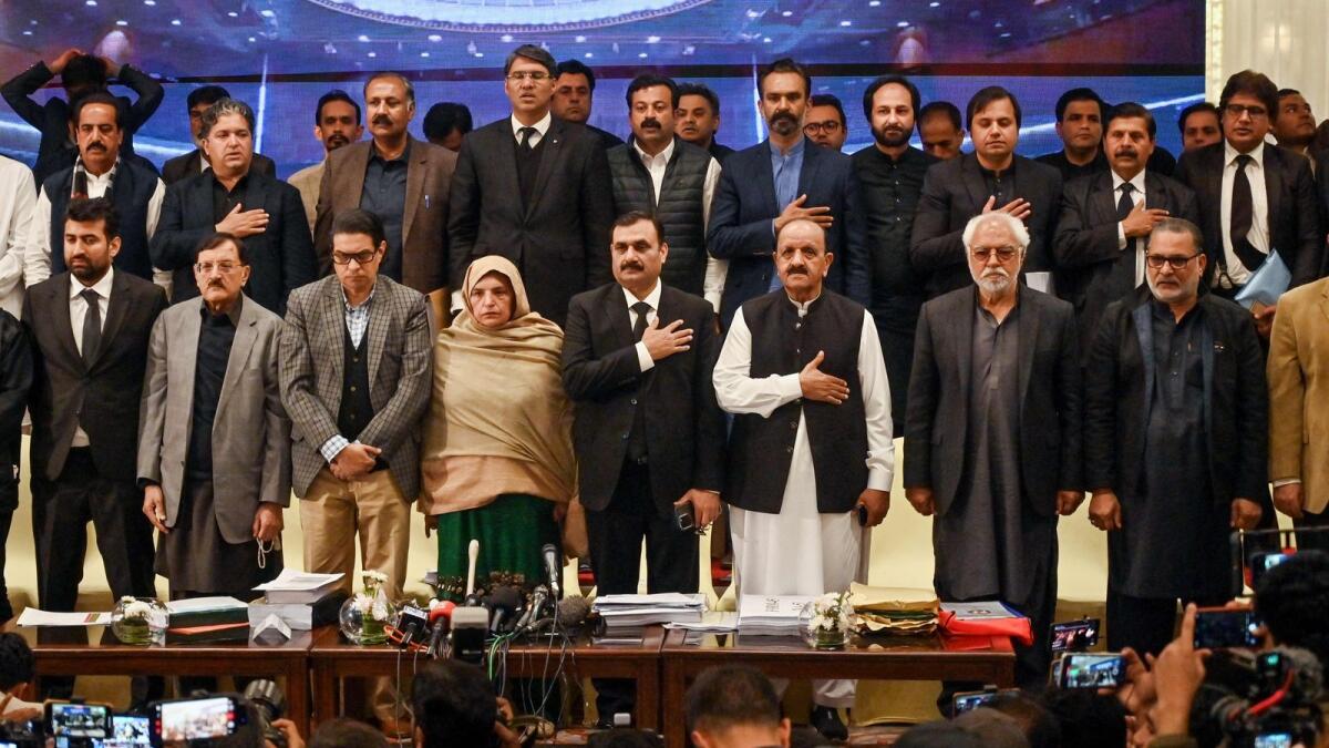 Senior Pakistan Tehreek-e-Insaf (PTI) party leaders stand for the national anthem before a press conference in Islamabad on Friday. Photo: AFP