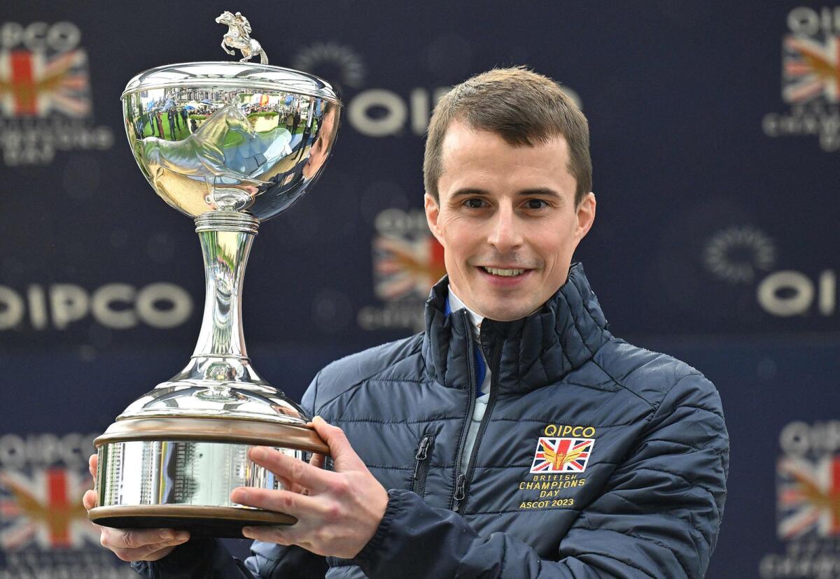William Buick poses with the Champion Jockey  trophy on British Champions Day at Ascot Racecourse,. - AFP