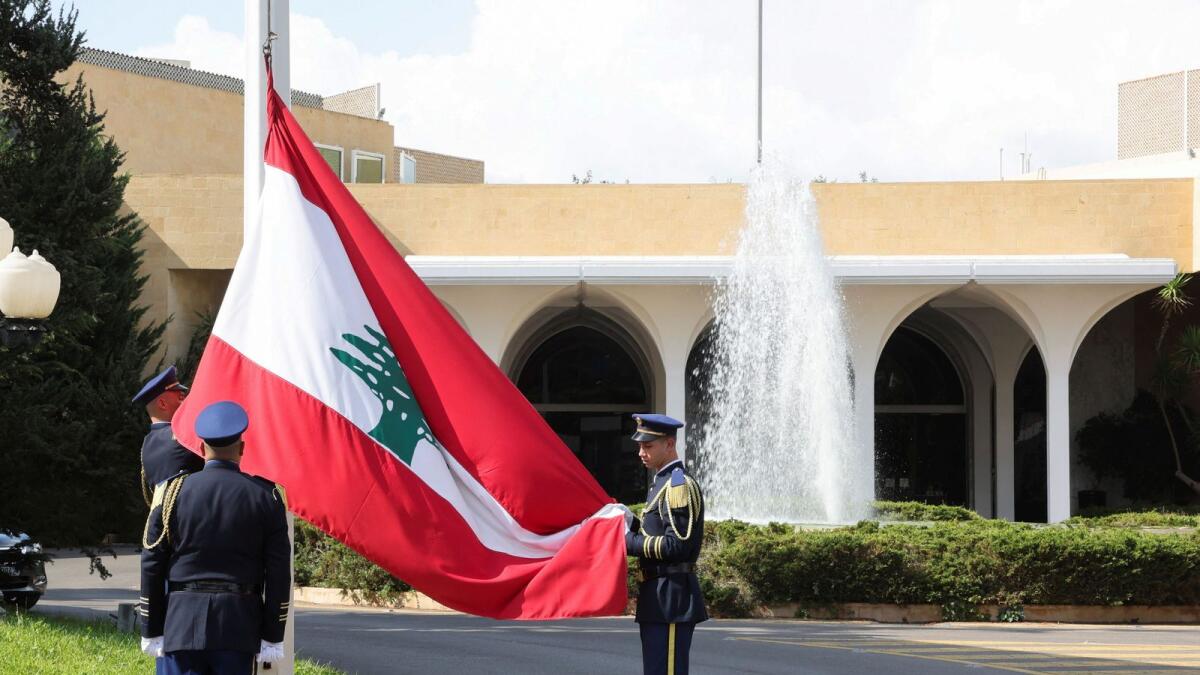 Members of the presidential guards remove a Lebanese flag after former Lebanese President Michel Aoun's six-year term officially ended, at the presidential palace in Baabda, Lebanon, November 1.  — Reuters