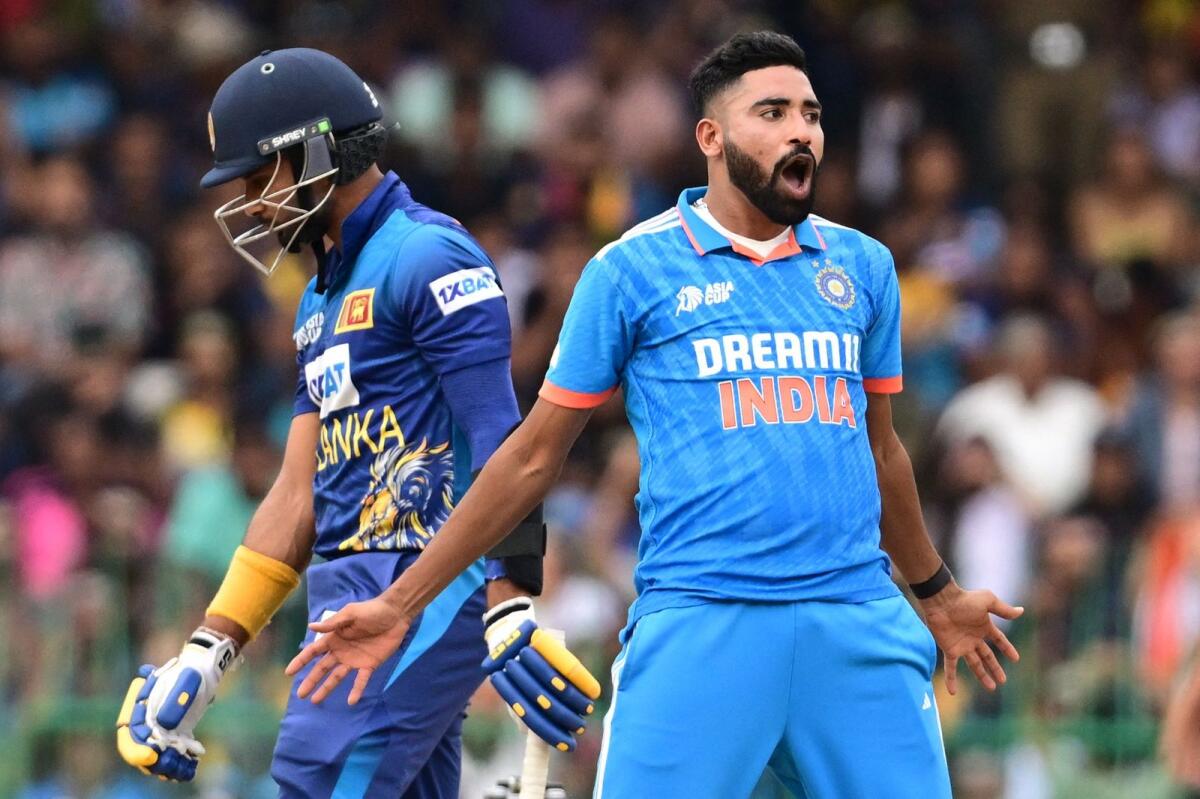 India's Mohammed Siraj (right) celebrates after taking the wicket of Sri Lanka's captain Dasun Shanaka. — AFP