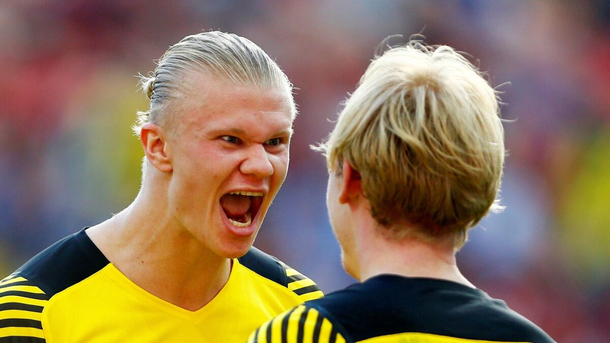 Borussia Dortmund's Erling Haaland celebrates his goal with Julian Brandt.— Reuters