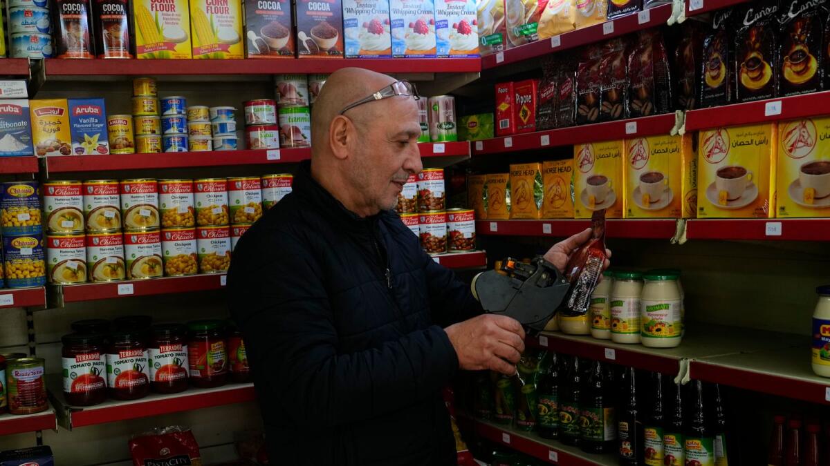 Moheidein Bazazo changes price tags from Lebanese pound to the  dollar in a shop in Beirut, Lebanon. Lebanon began pricing consumer goods in supermarkets in US dollars. — AP