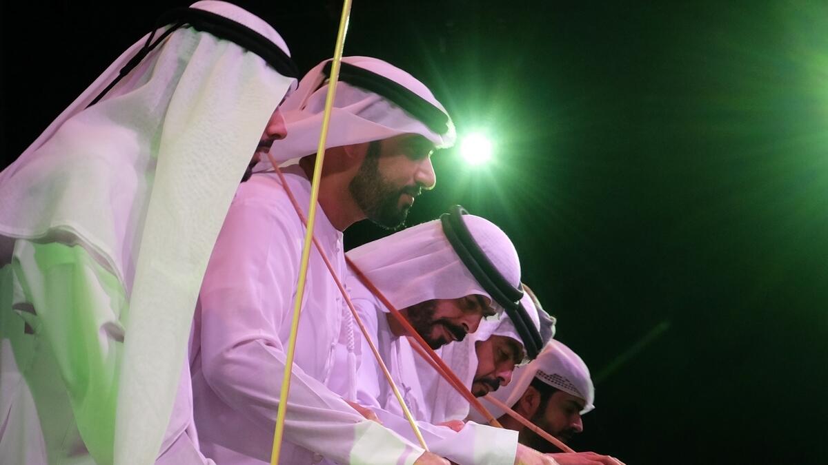 Emirati men perform the traditional Yollah dance at the festival.