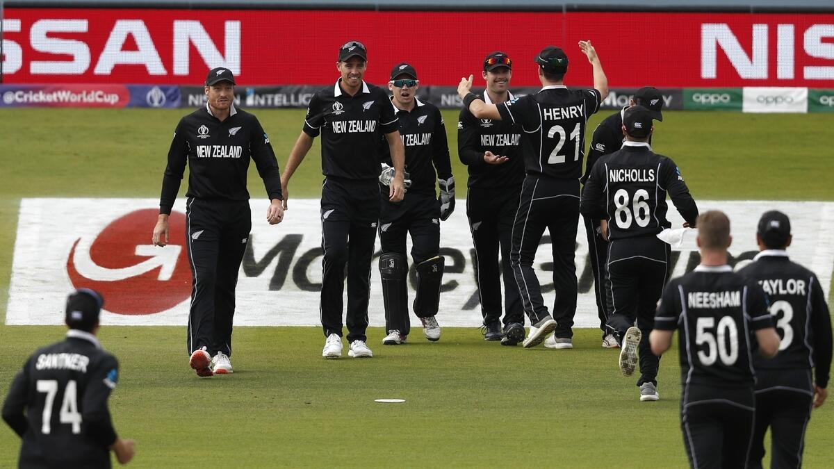 New Zealand players celebrate their win over India in the Cricket World Cup semi-final match at Old Trafford.
