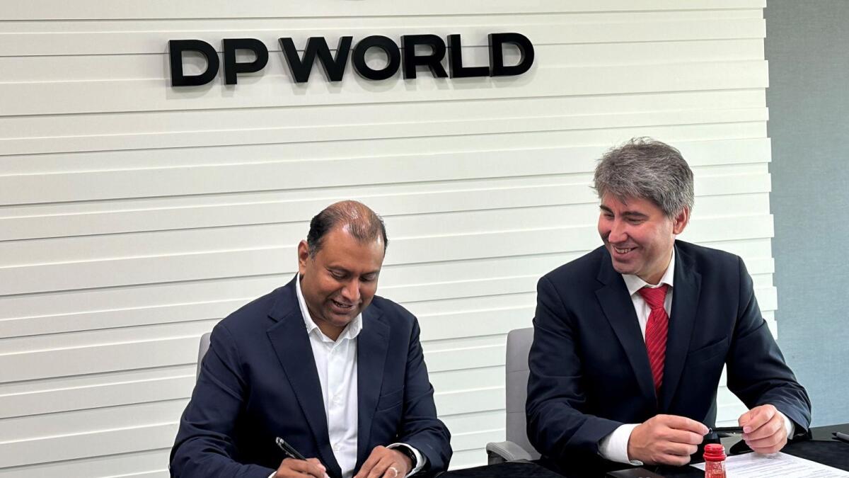 Mike Bhaskaran, Group Chief Technology Officer, Digital Technology, DP World and Murat Seitpesinov, Chairman of the Integral Petroleum Group sign the agreement. - WAM