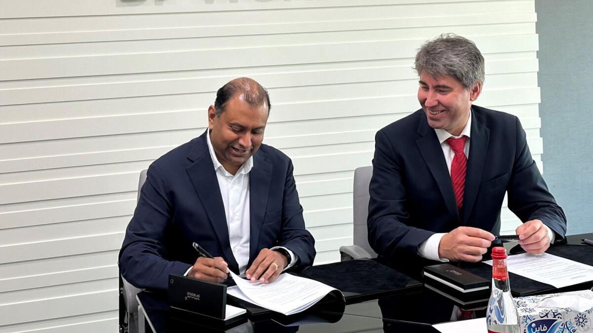Murat Seitpesinov, chairman of the Integral Petroleum Group; and Mike Bhaskaran, group chief technology officer, Digital Technology, DP World; signing the agreement. — Supplied photo