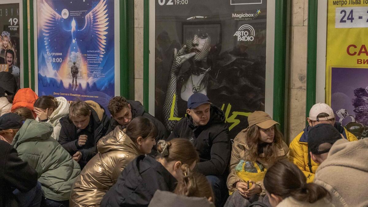 People take shelter in the Khreshchatyk metro station during an air strike alarm in Kyiv on Saturday. — AFP