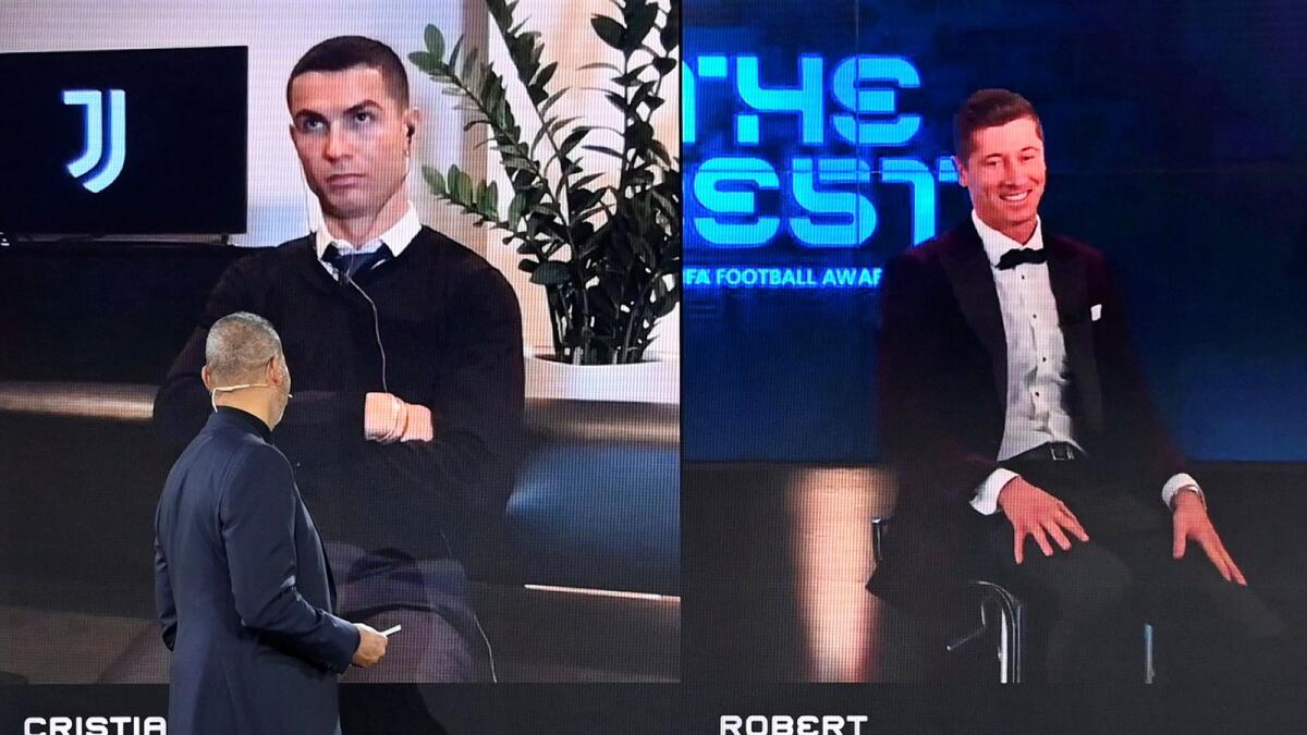 Robert Lewandowski is awarded The Best Fifa Men's Player as Cristiano Ronaldo looks on.