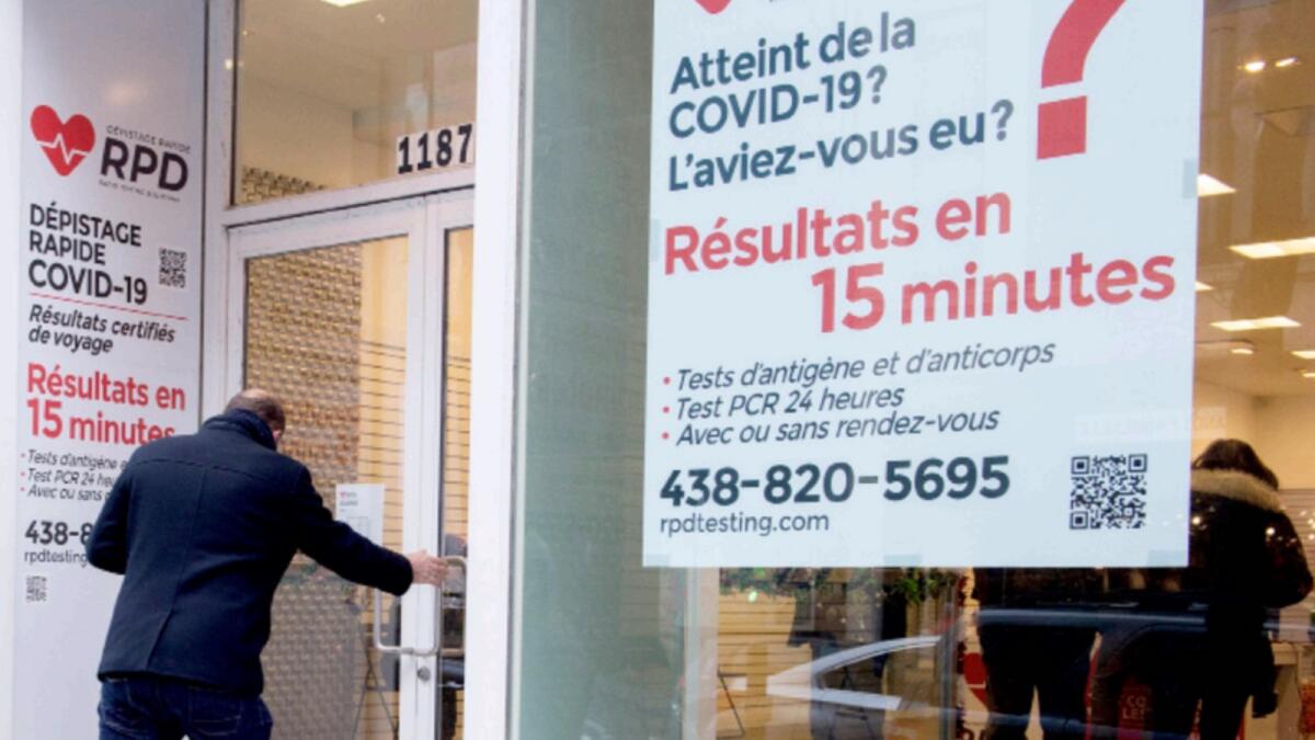 People enter a Covid-19 rapid testing business in Montreal. — AP