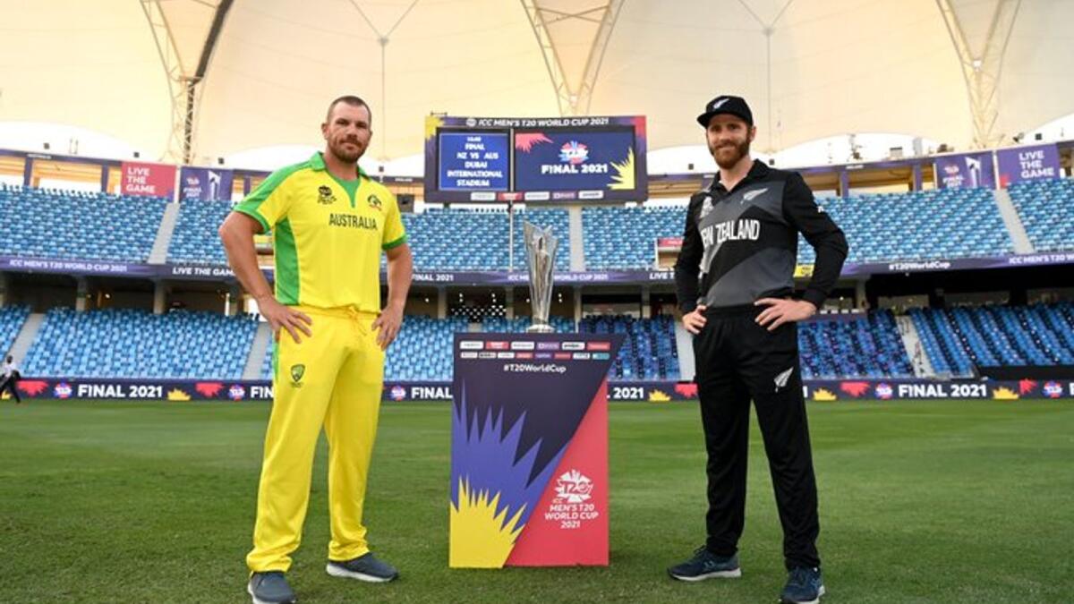 Australian captain Aaron Finch (left) and New Zealand skipper Kane Williamson pose with the T20 World Cup trophy in Dubai on Saturday. — ICC Twitter