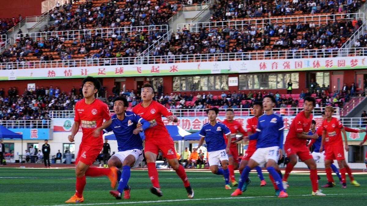 Players of Lhasa Chengtou (in blue) and Zibo Sunday (in red) compete for the ball during their 2017 Chinese Football Association Amateur League football match at the People's Cultural and Sports Center, located at a height of 3,658 metres (12,000 ft.) above sea level, in Lhasa in China's western Tibet Autonomous Region. -- AFP file