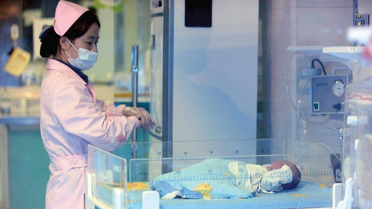 A nurse checks on a baby in a hospital in Xichang, southwest China’s Sichuan province. — AFP