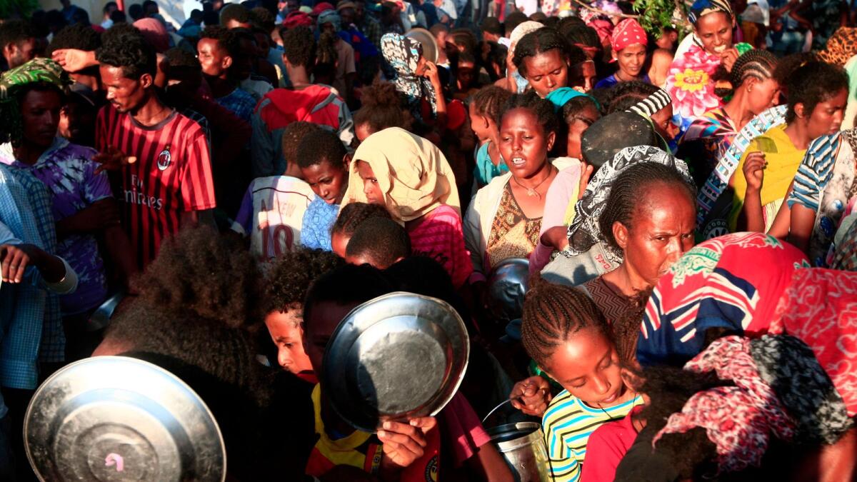 Ethiopian migrants who fled intense fighting in their homeland of Tigray,  wait for their ration of food in the border reception centre of Hamdiyet, in the eastern Sudanese state of Kasala, on Saturday.