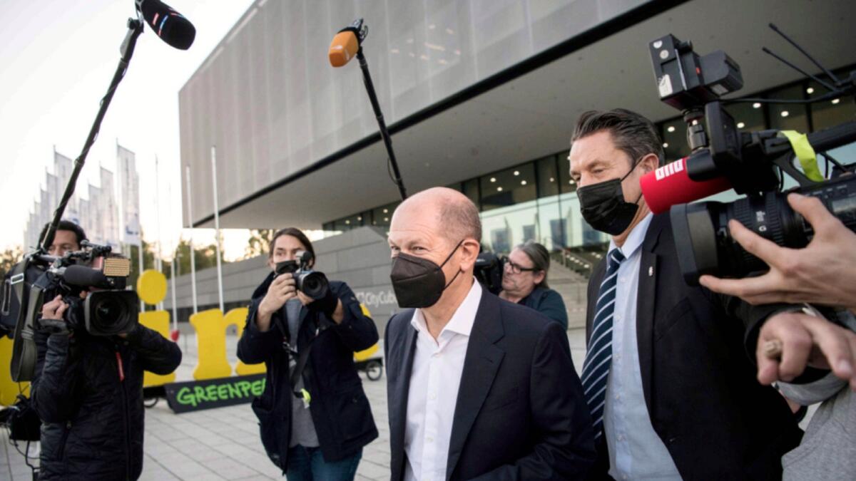 Social Democratic Party candidate for chancellor Olaf Scholz  leaves after talks with the SPD, FDP and Green party in Berlin. — AP