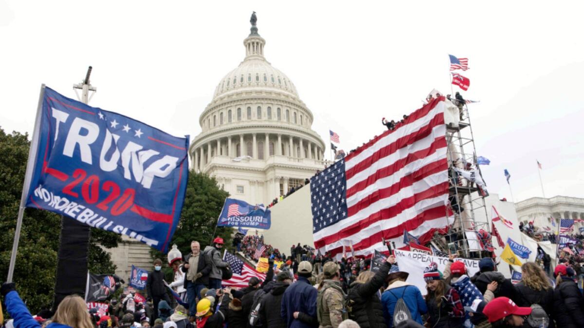 Violent insurrectionists loyal to Donald Trump stand outside the US Capitol in Washington on Jan. 6, 2021. — AP file