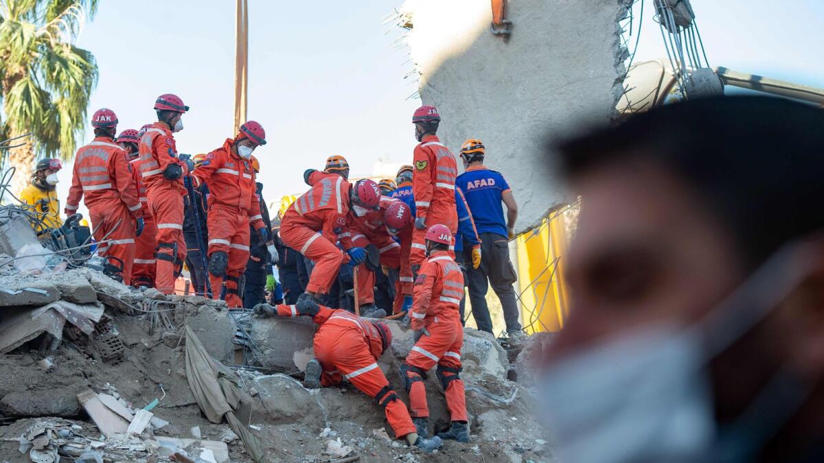 Rescuers are at work during the ongoing search operation at the site of a collapsed building as they look for survivors and victims in the city of Izmir. AFP