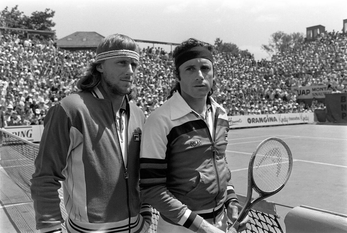 Sweden's tennis player Bjorn Borg (L) and Argentinian Guillermo Vilas pose before the men's single final, at the French tennis Open of Roland Garros, 11 June 1978. Borg won the match. Photo: AFP
