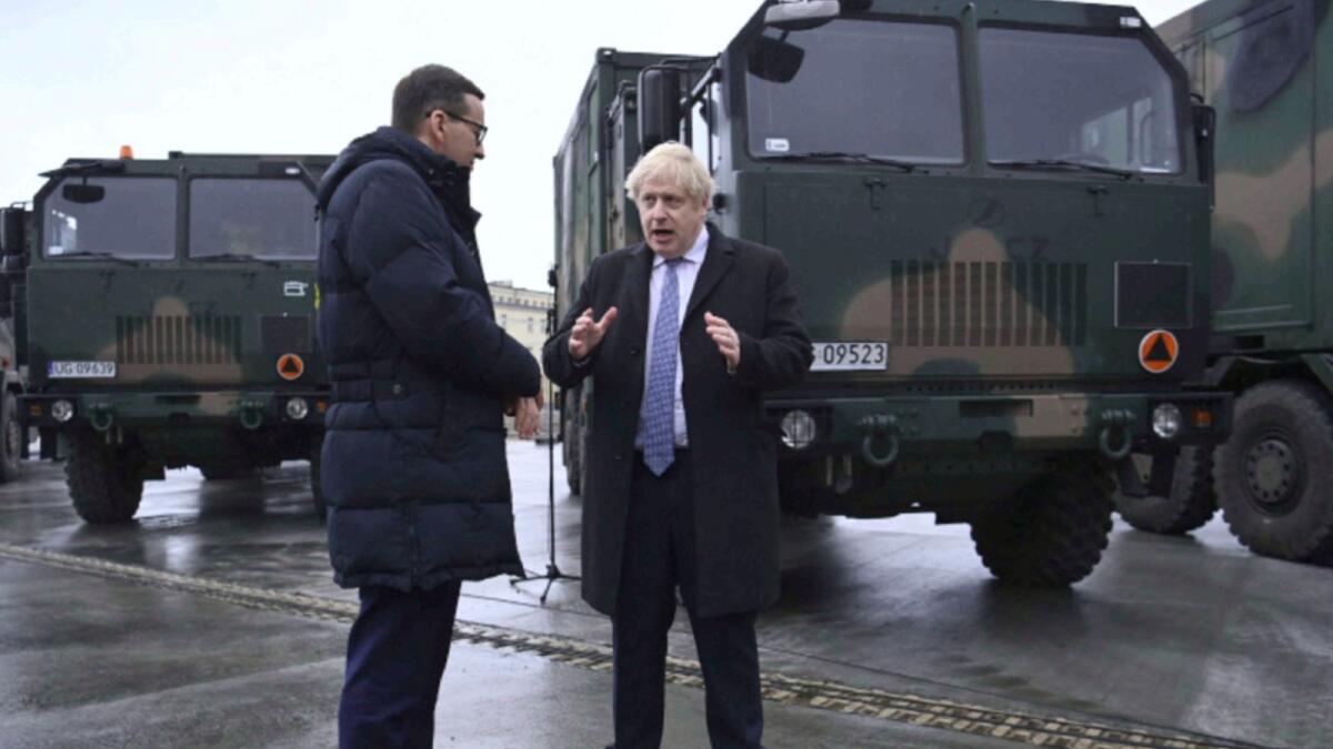 British Prime Minister Boris Johnson, right, and his Polish counterpart Mateusz Morawiecki visit the Warszawska Brygada Pancerna military base near Warsaw, Poland. — AP