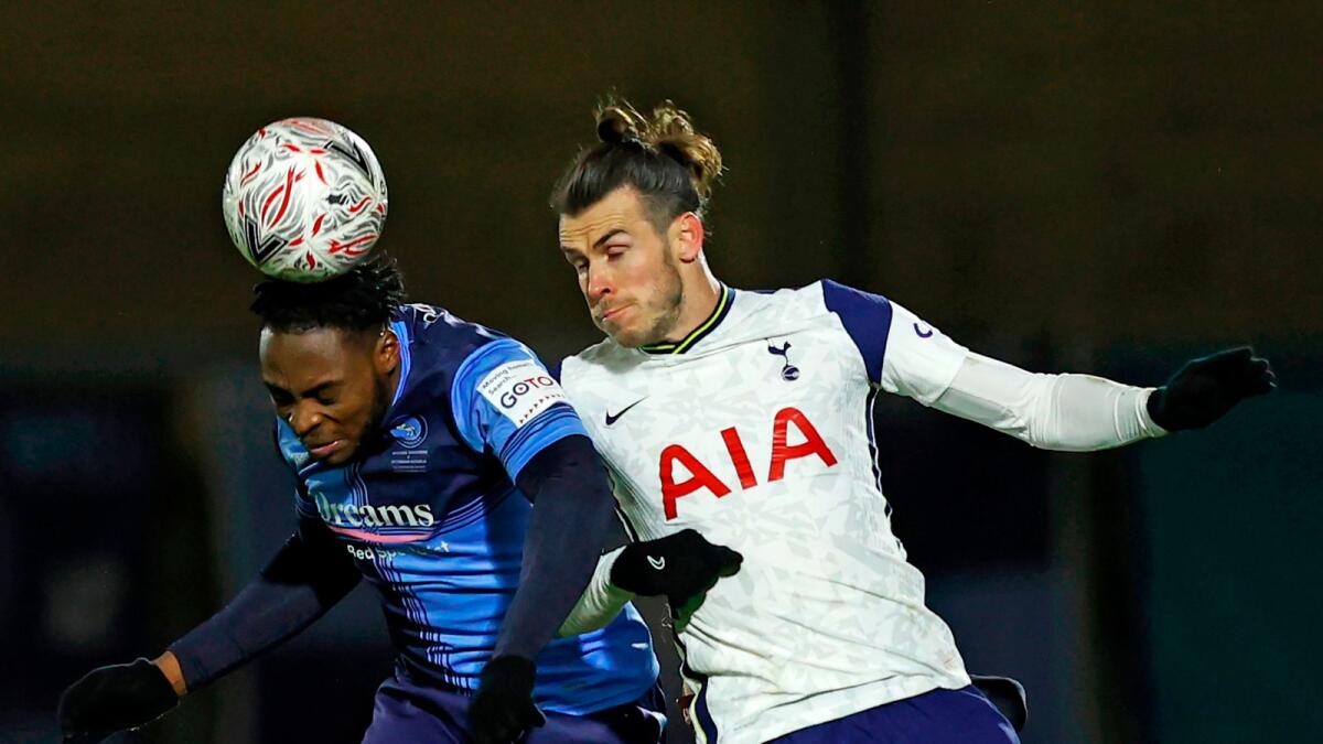 Wycombe Wanderers' Fred Onyedinma (left) vies with Tottenham Hotspur's Gareth Bale. (AFP)