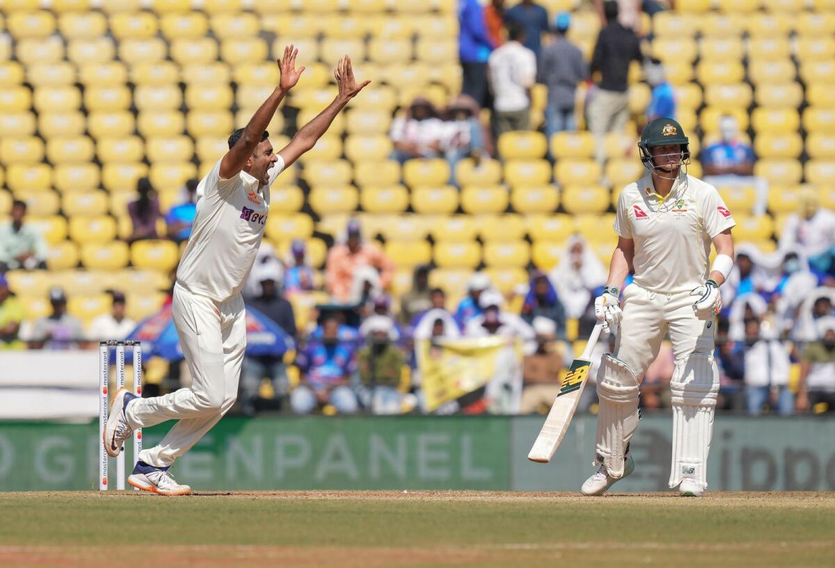 India's Ravichandran Ashwin celebrates the wicket of Australian batter David Warner. — PTI