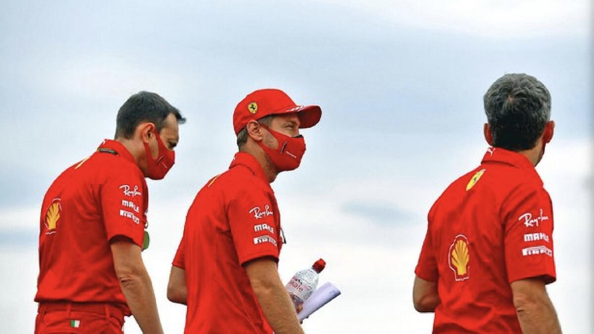 Sebastian Vettel and Ferrari team members walk along the track on Thursday. - (Ferrari Twitter)