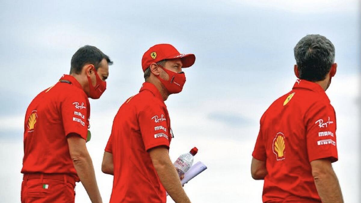 Sebastian Vettel and Ferrari team members walk along the track on Thursday. - (Ferrari Twitter)