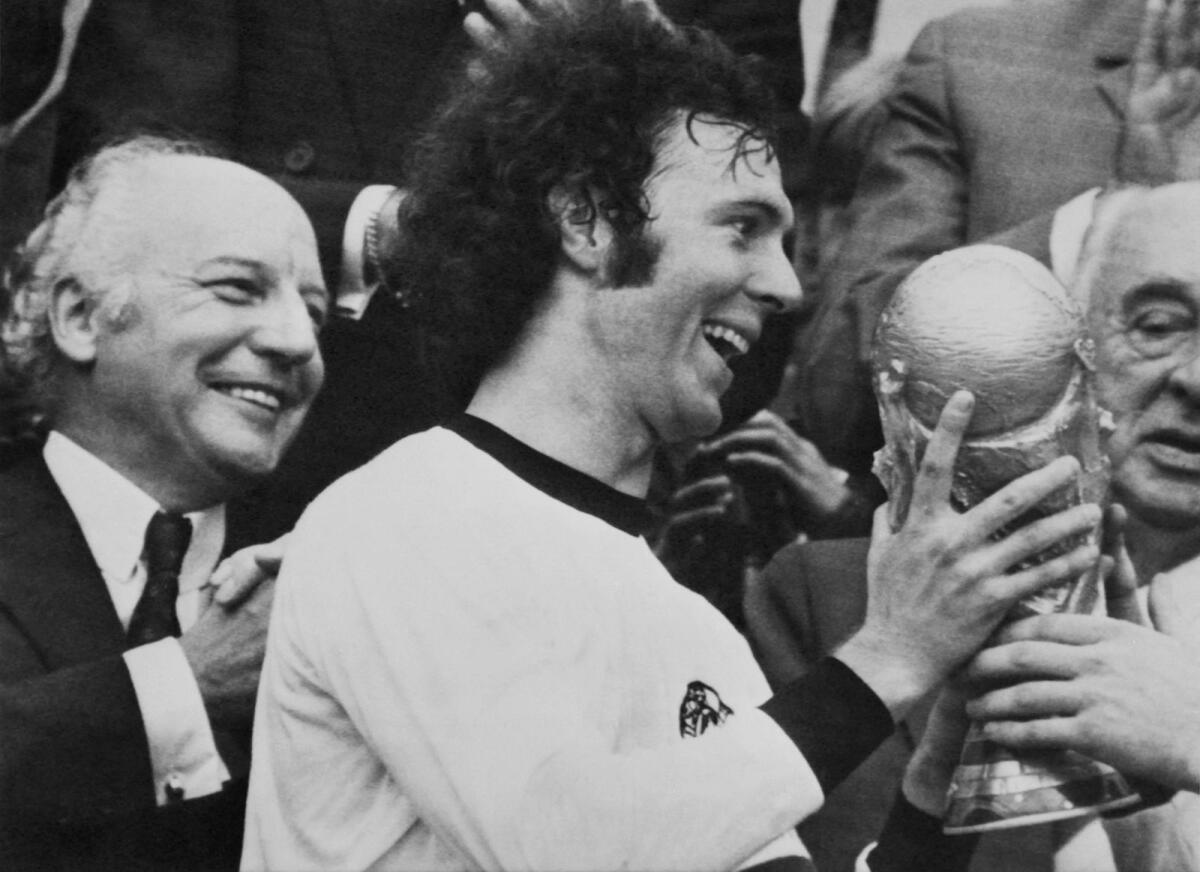 Franz Beckenbauer holds the World Cup trophy after his team's victory over the Netherlands. — AFP