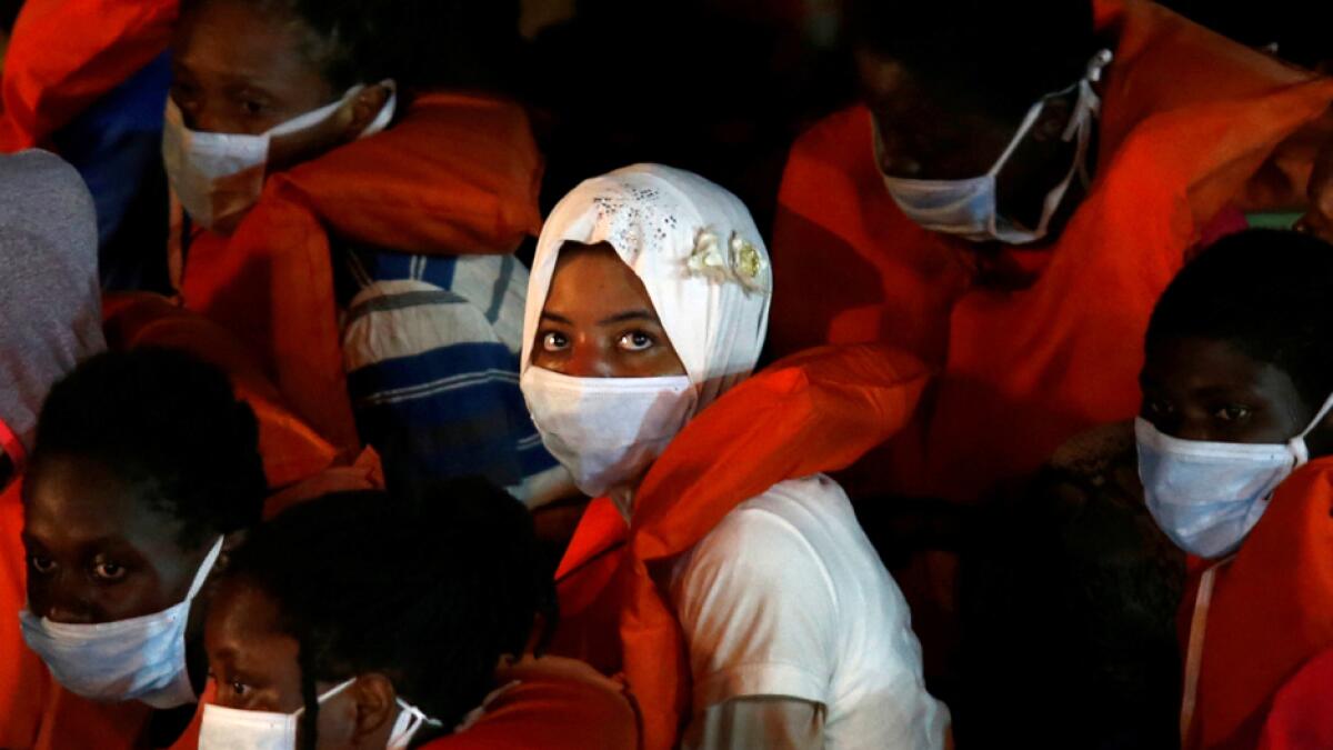 Rescued migrants look on from onboard an Armed Forces of Malta vessel upon their arrival in Senglea, in Valletta's Grand Harbour, as the coronavirus disease outbreak continues in Malta. Photo: Reuters