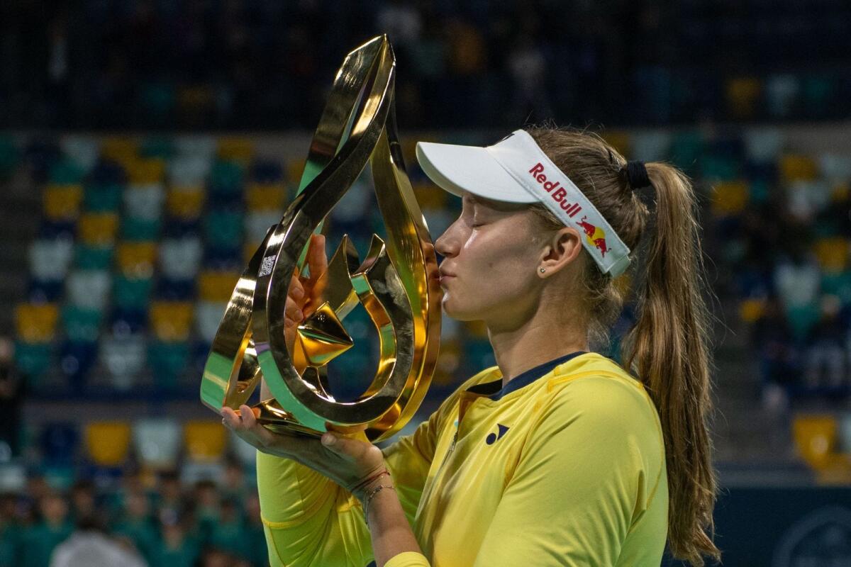 Elena Rybakina of Kazakhstan kisses the trophy after winning the Mubadala Abu Dhabi Open final on Sunday. — AFP