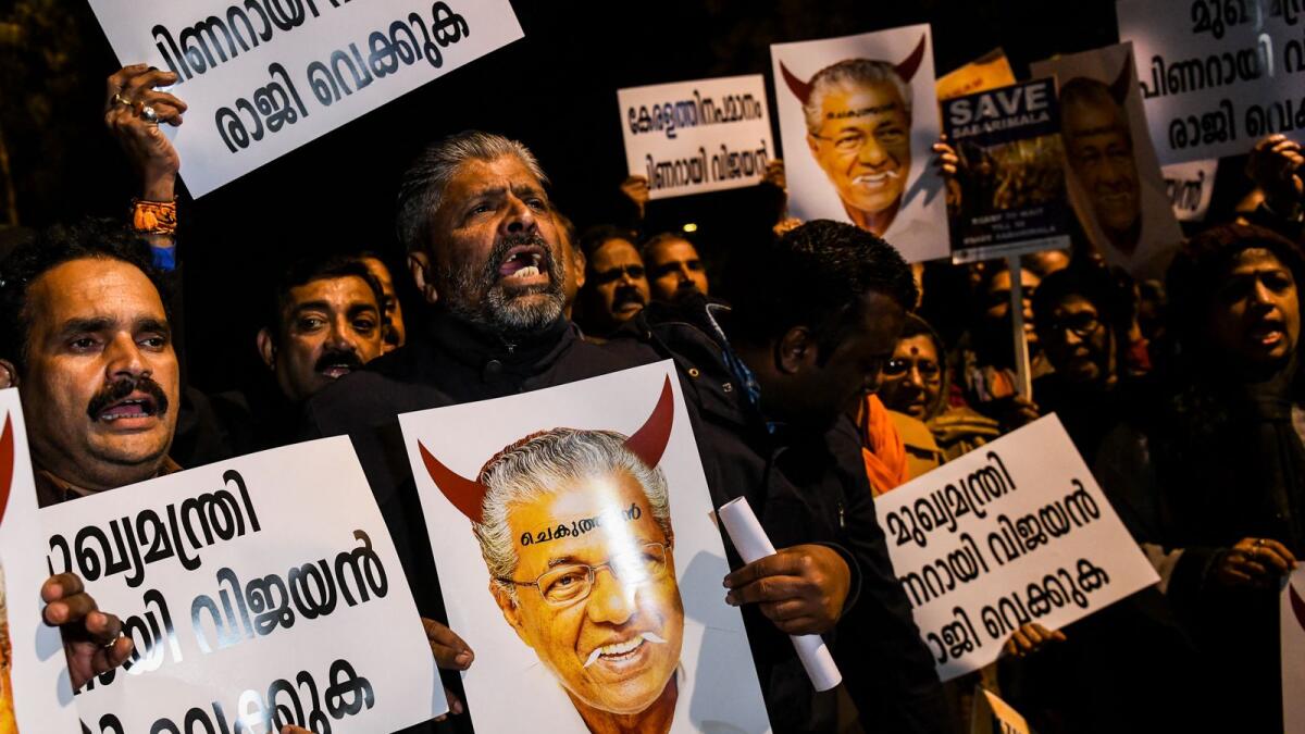 Protesters hold placards bearing the image of Kerala Chief Minister Pinarayi Vijayan during a demonstration over the Sabarimala temple issue. Photot: AFP