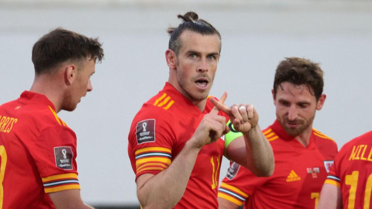 Wales' forward Gareth Bale (centre) celebrates with teammates after scoring his third goal during the Fifa World Cup Qatar 2022 qualification match against Belarus. — AFP