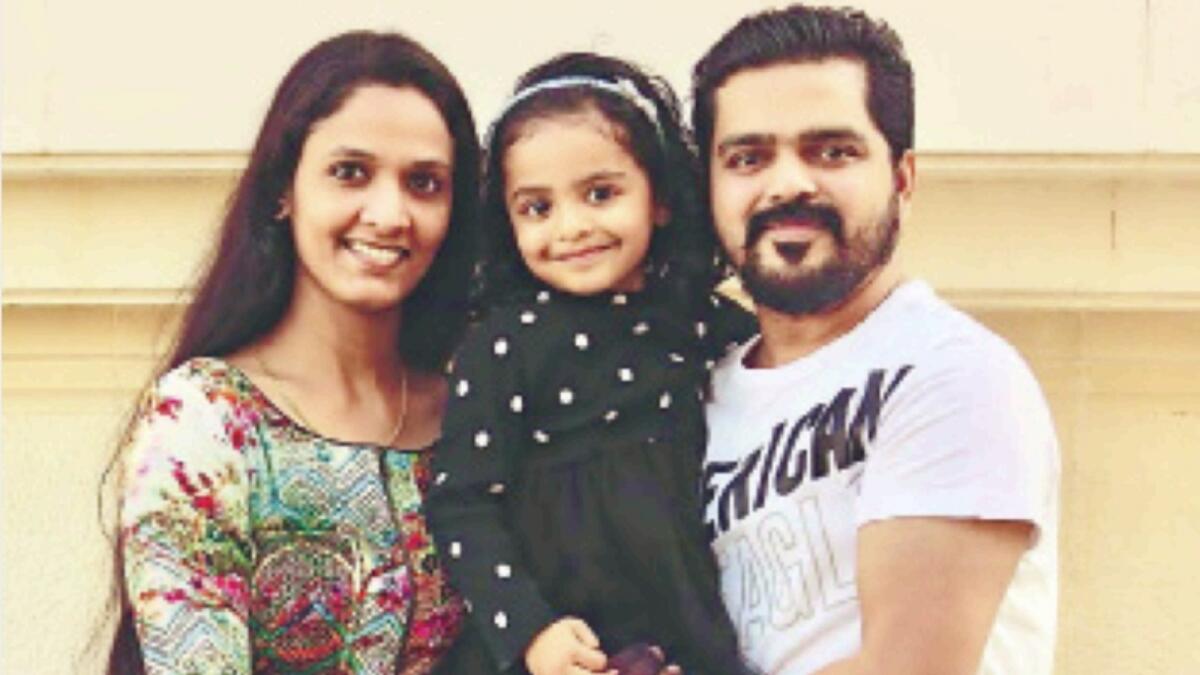 Athira and Rakesh with their daughter. — Supplied photo