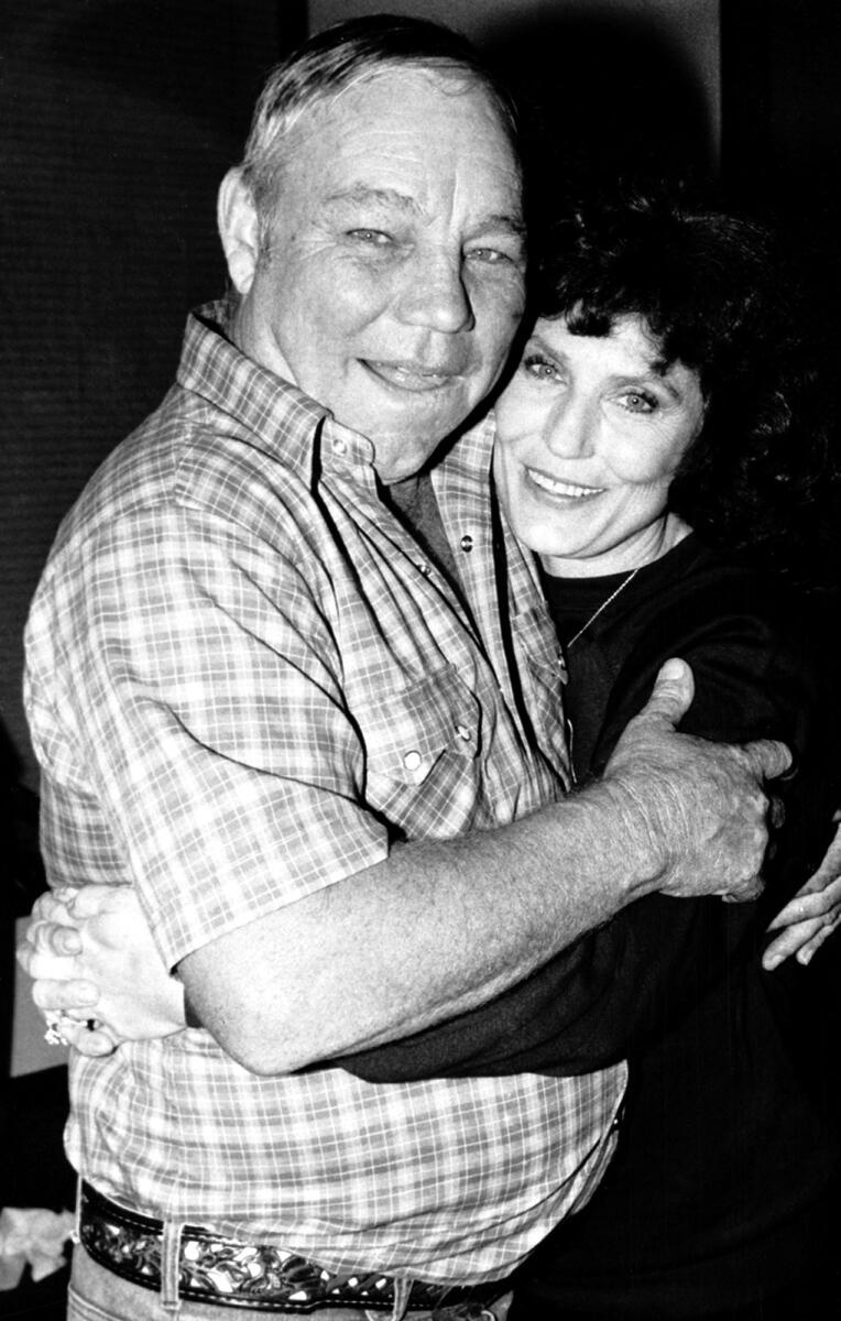 Country music singer Loretta Lynn embraces her husband, Oliver 'Mooney' Lynn, during rehearsal for her New York debut, on Oct. 21, 1982