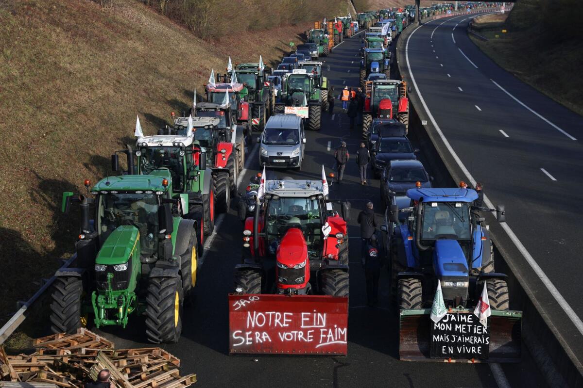 Tractors and other vehicles queue on the A16 highway as French farmers try to reach Paris during a protest over price pressures, taxes and green regulation, grievances shared by farmers across Europe, in Beauvais, France, on Monday. — Reuters