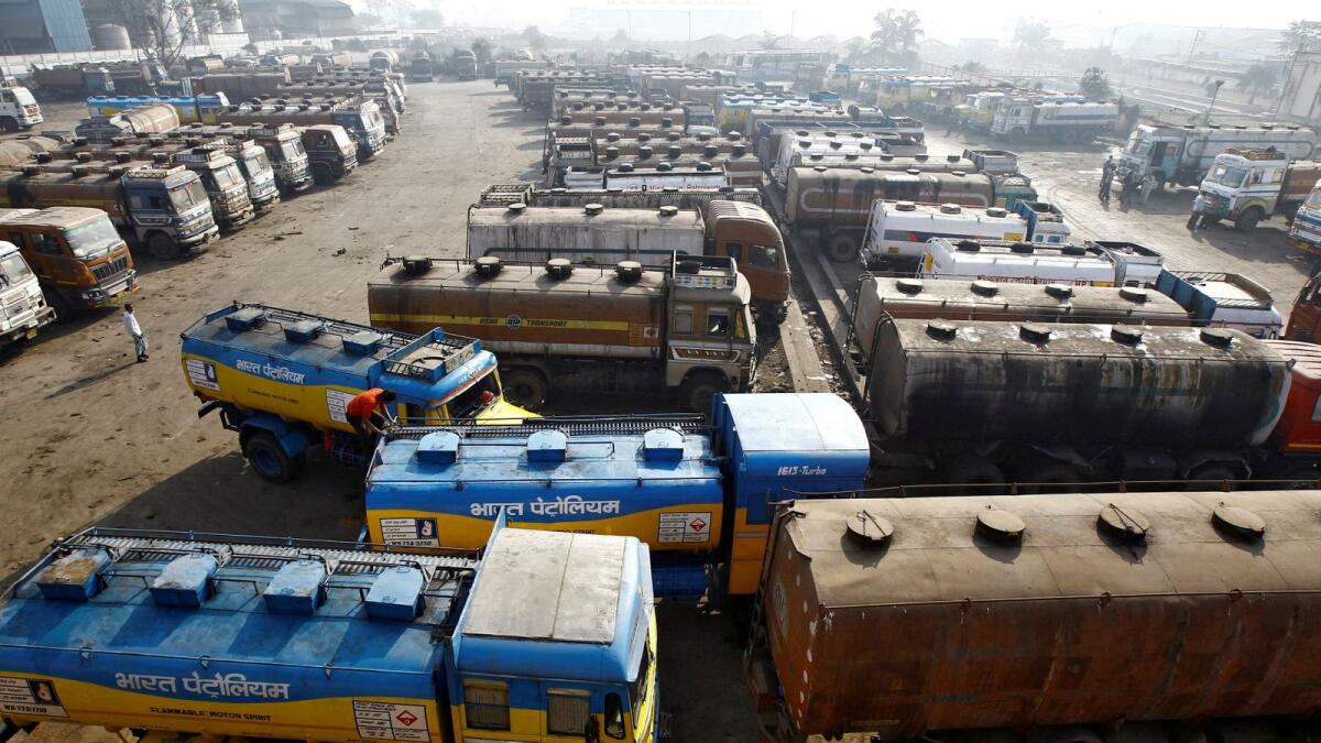 Oil tankers are seen parked at a yard outside a fuel depot on the outskirts of Kolkata. — Reuters file