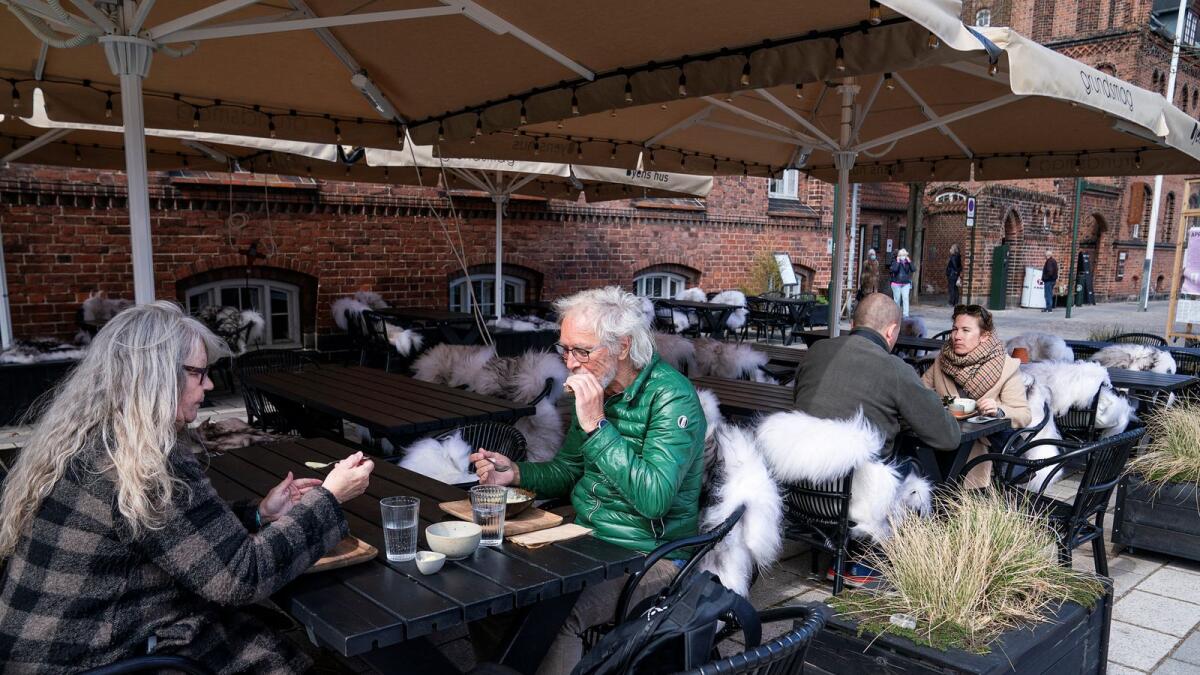 People enjoy outdoor service at a cafe in Roskilde, Denmark. Photo: FP