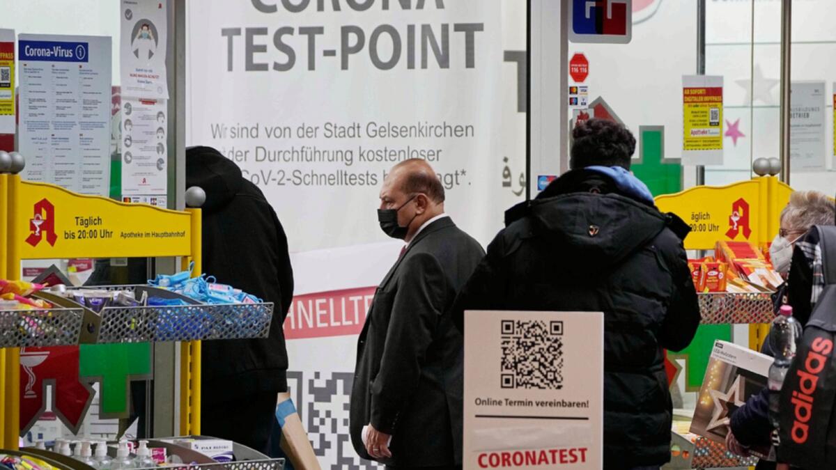 A man walks into a pharmacy that offers corona tests in Gelsenkirchen, Germany. — AP