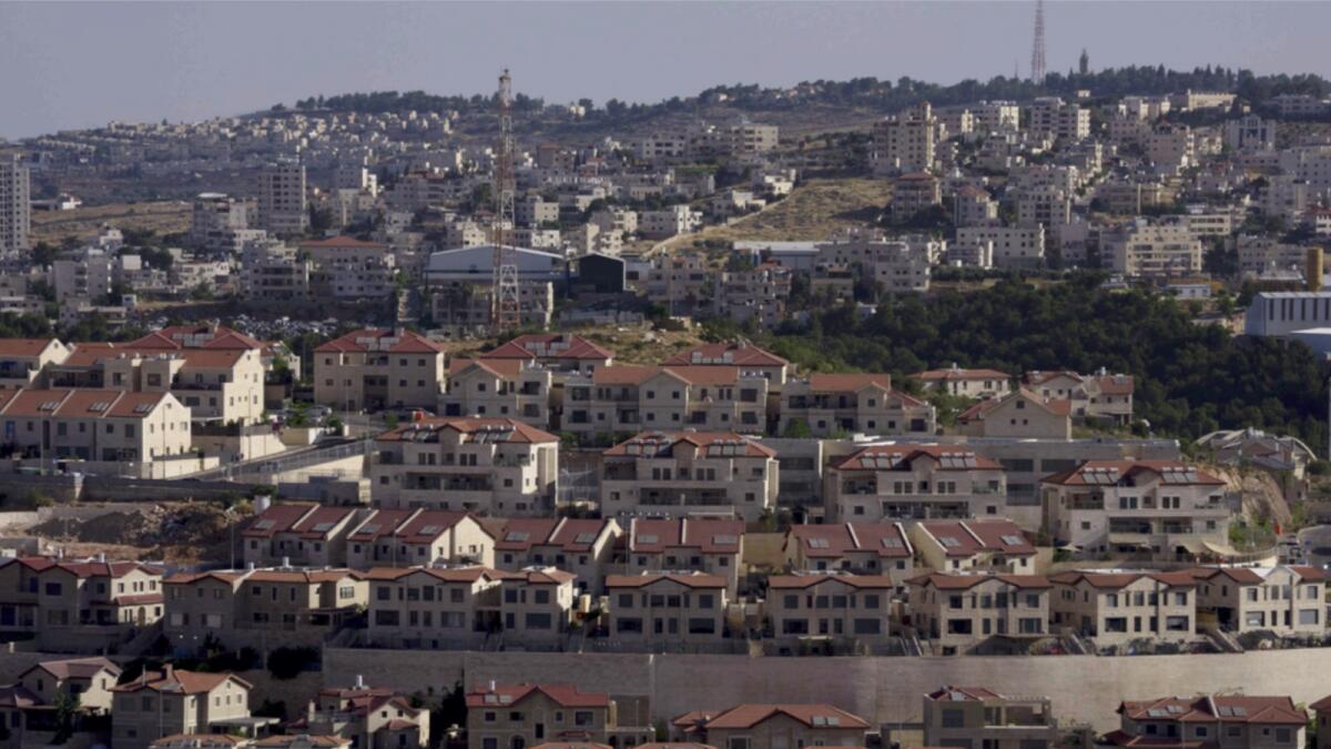 Palestinian buildings are seen behind a section of the West Bank Jewish settlement of Efrat. — AP