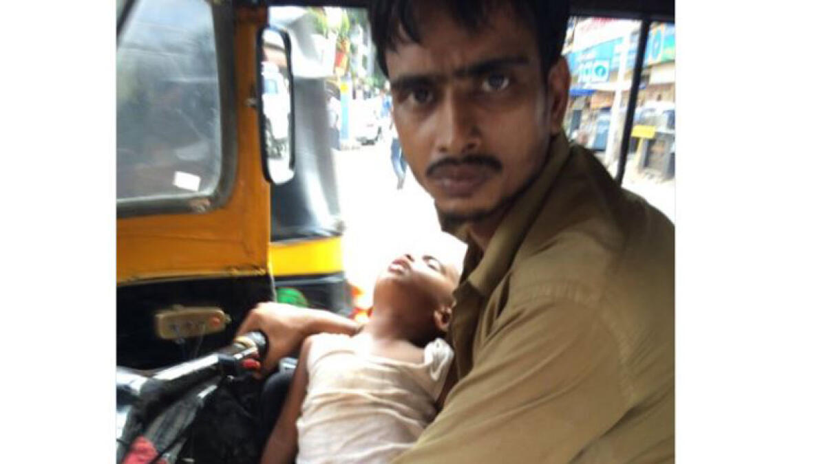 Indian driver gets help after picture with 2-year-old son goes viral