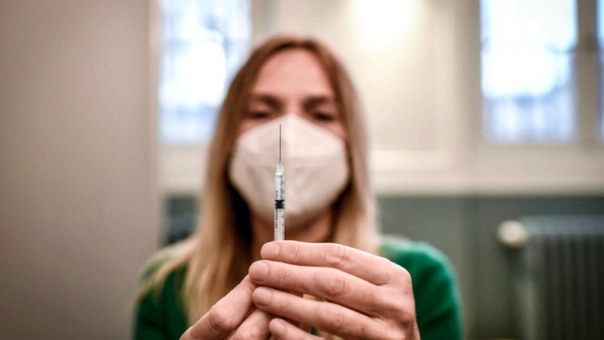 A medical staff member prepares a syringe with a dose of the Pfizer-BioNTech Covid-19 vaccine at a temporary vaccination centre in Paris. — AFP