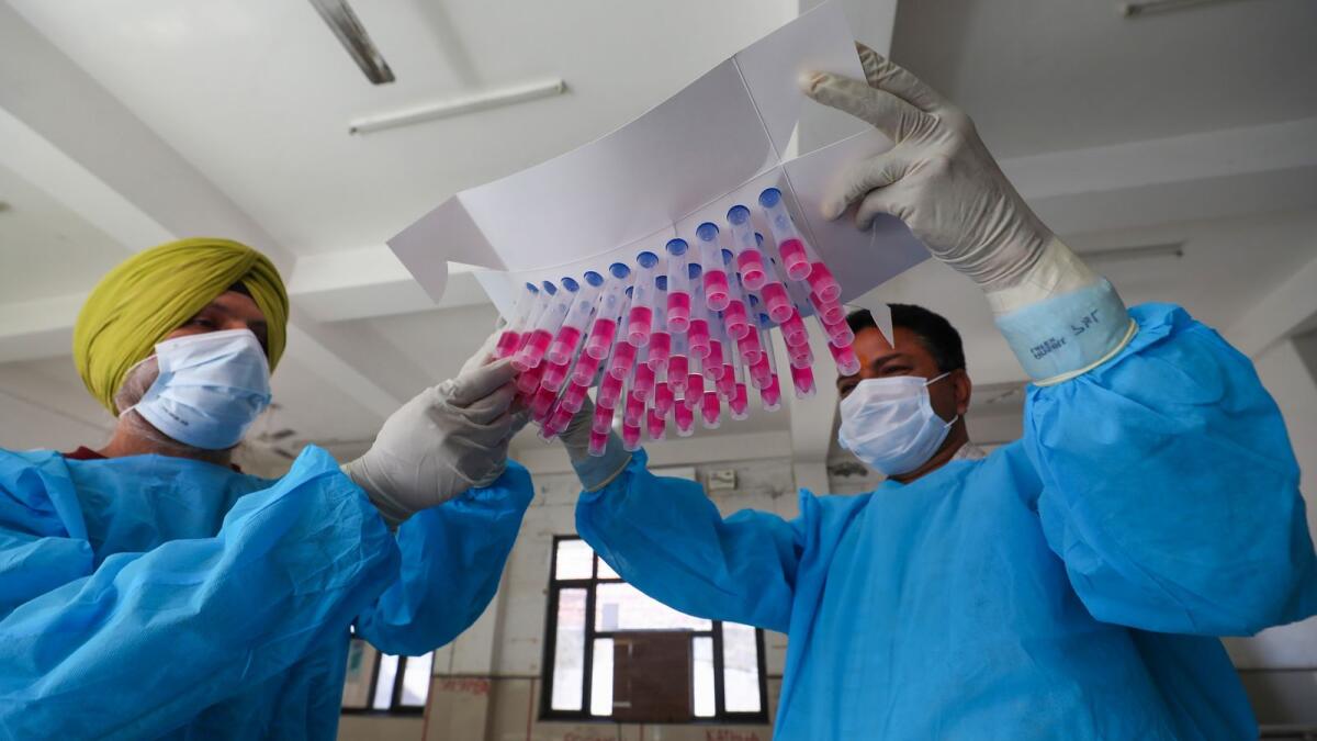 Healthcare workers show swab samples for Covid-19 test, amid a rise in coronavirus cases in Jammu, on Saturday, April 22, 2023. — PTI