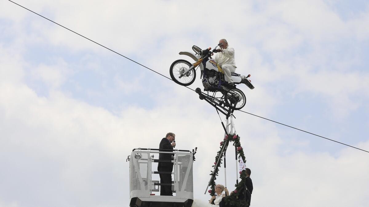 Couple gets married dangling from motorcycle atop tightope