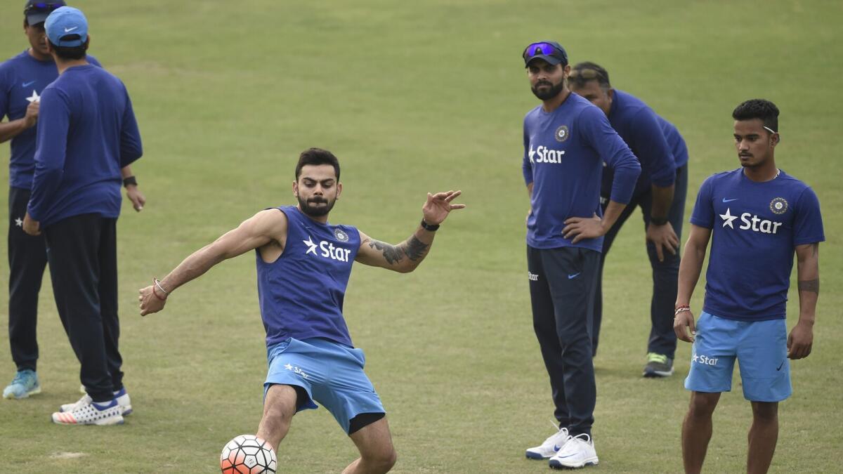 Indian crikceter Virat Kohli (2L) plays football with teammates during a training session at the Khan Shaheb Osman Ali Stadium in Fatullah . 