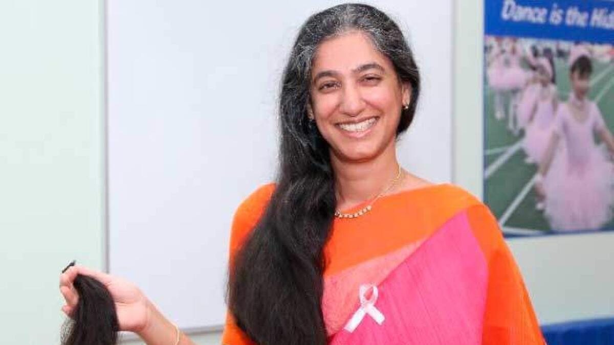 The Millennium School principal Ambika Gulati with her lock of hair cut for donation as part of the Pink Day celebration.
