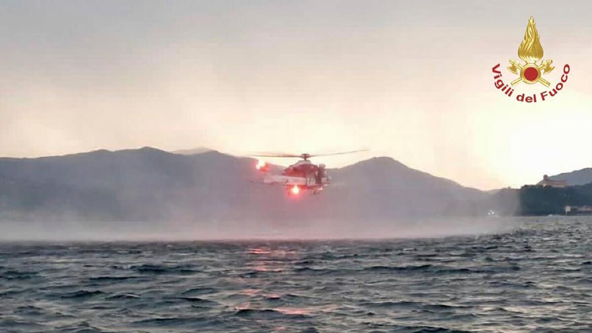 A helicopter search for missing after a tourist boat capsized in a storm on Italy's Lago Maggiore in the northern Lombardy region, on Sunday. — AP