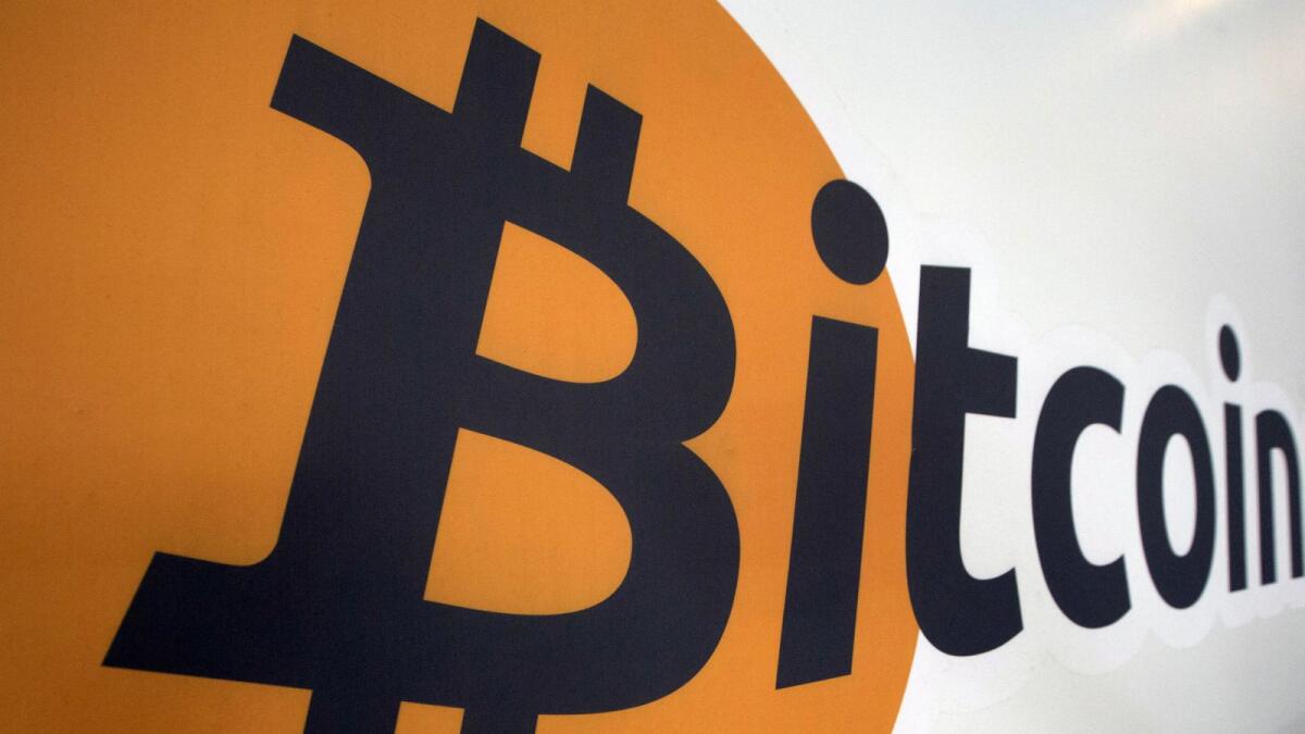 A Bitcoin logo is displayed at the Bitcoin Centre in New York. The original crypto coin has leapt 20 per cent to two-month highs at $30,182 over the past 11 days. — Reuters file