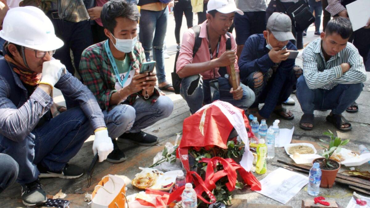 People mourn at the site where a young man died during a protest against the military coup, in Yangon, Myanmar. —AP